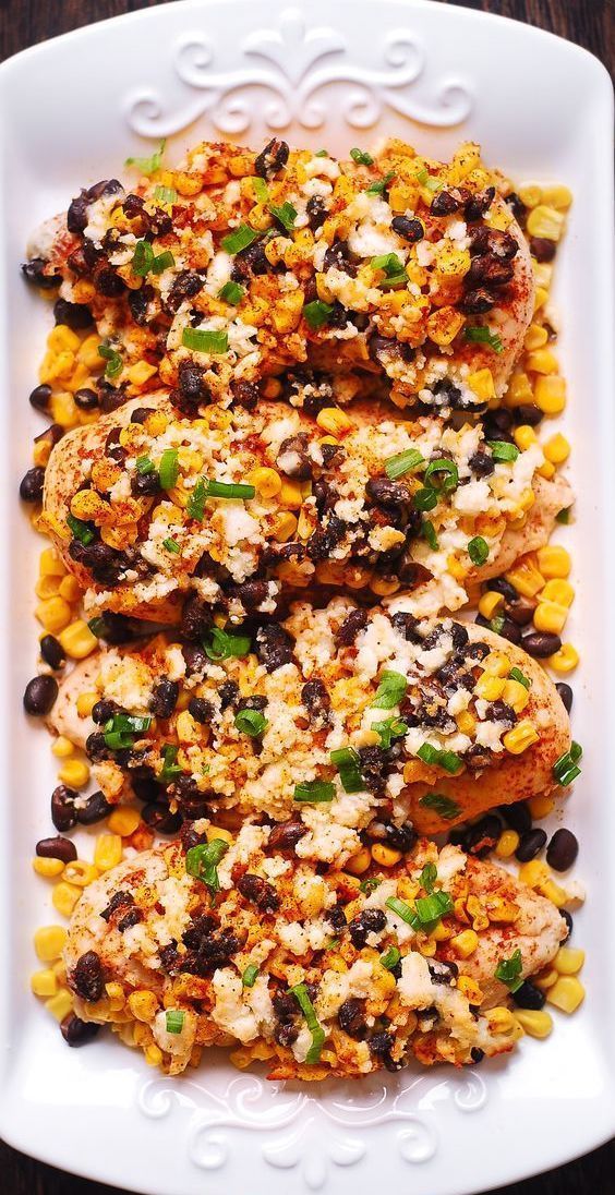 grilled chicken with corn and black beans on a white platter, ready to be eaten