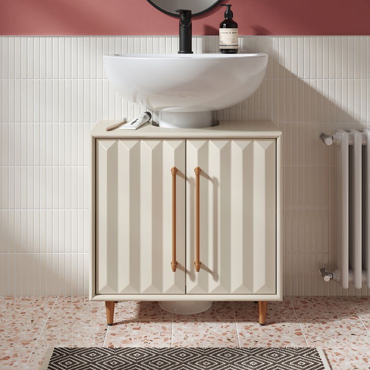 a bathroom with a sink, mirror and rug