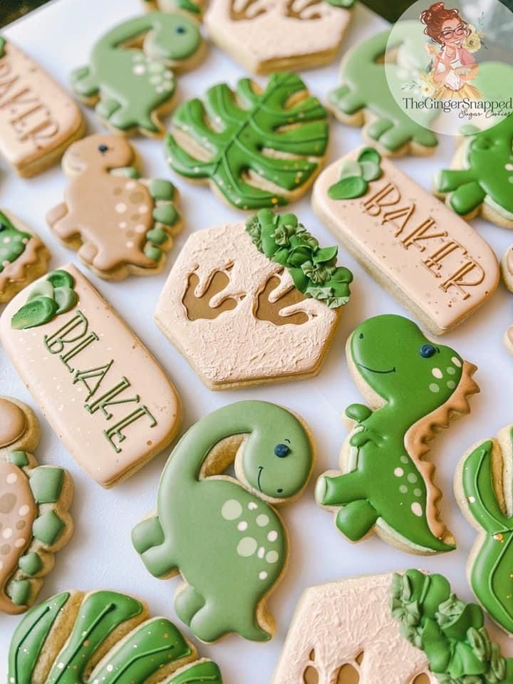 some cookies are decorated with green and white icing