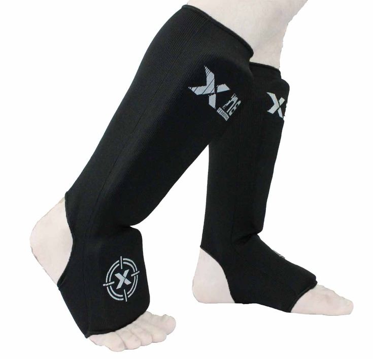 the legs and ankles of a dog wearing black knee pads with white letters on them