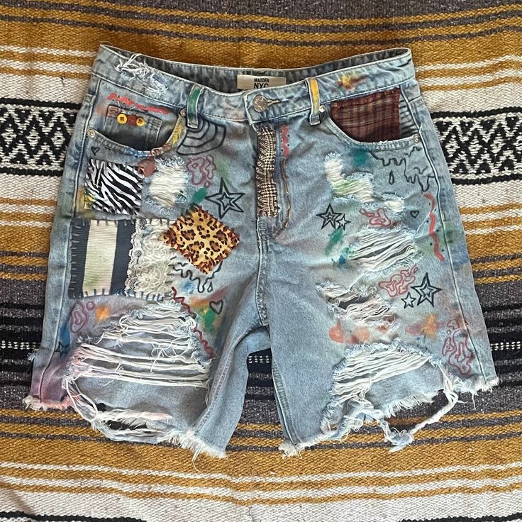 a pair of destroyed shorts with patches on them