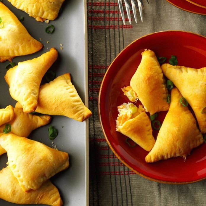 several pastries on red plates next to silverware