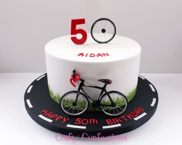 a birthday cake with a bicycle on top