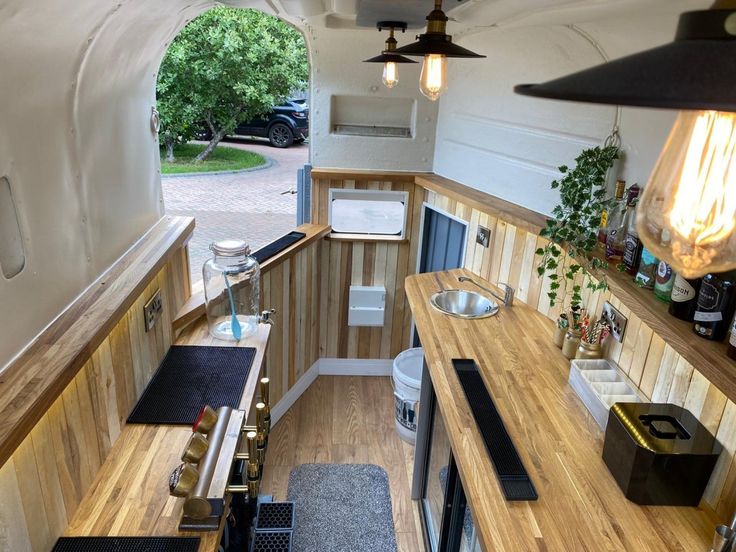 an interior view of a tiny house with wood flooring and walls that have been built into the ceiling