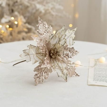 a paper snowflake sitting on top of a table next to a christmas tree