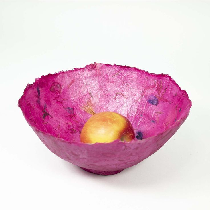 a purple bowl with an apple in it