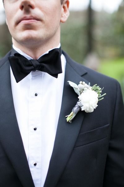 a man in a tuxedo with a boutonniere on his lapel