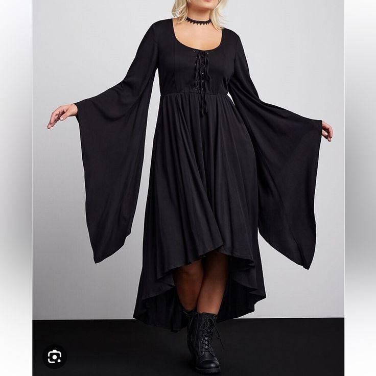 Nwt New In Package Torrid Plus Size Halloween Collection Size 2 2x 18-20 This Costume-Dress Screams Spooktacular With Its Exaggerated Hi-Lo Hem, Voluminous Bell Sleeves, And Lace-Up Front. Make This All Hallows Eve One To Remember, And One That Will Turn Heads (Maybe All The Way Around)! Stretch Challis Woven Fabric Scoop Neck; Lace-Up Front Extra-Long Bell Sleeves Front Pockets Maxi Hi-Lo Hem Content + Care Rayon/Spandex Wash Cold; Dry Low Imported Plus Size Costume Dresses #Halloween #Cosplay Plus Size Alternative Fashion, Halloween Oc, Laceup Dress, Witch Style, Plus Size Costume, 2024 Halloween, All Hallows Eve, Witch Fashion, Plus Size Halloween