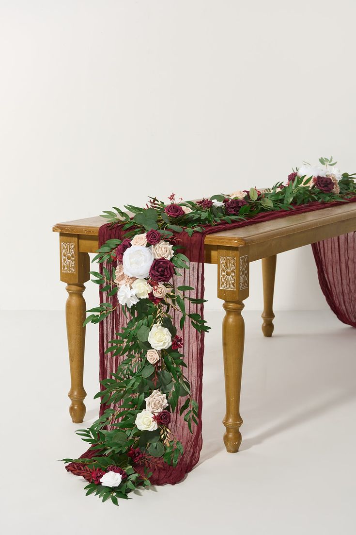 the table is decorated with flowers and greenery