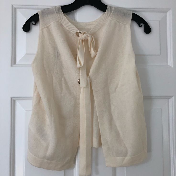 Brand New With Tags. Designer Size 1. Cream Colored. Elegant Beige Knit Top For Work, Winter Cashmere Tops For Daywear, Elegant Sleeveless Cashmere Tops, Elegant Cashmere Knit Top For Layering, Chic Fine Knit Sweater For Daywear, Elegant Spring Cashmere Top, Chic Spring Sweater Vest, Elegant White Sweater Vest For Spring, Spring Beige Cashmere Tops