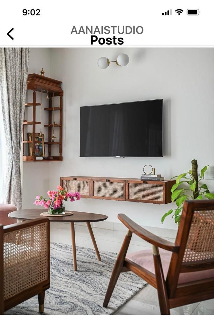 a living room filled with furniture and a flat screen tv mounted to the side of a wall