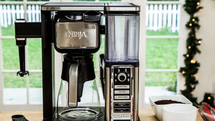 a coffee maker sitting on top of a wooden table