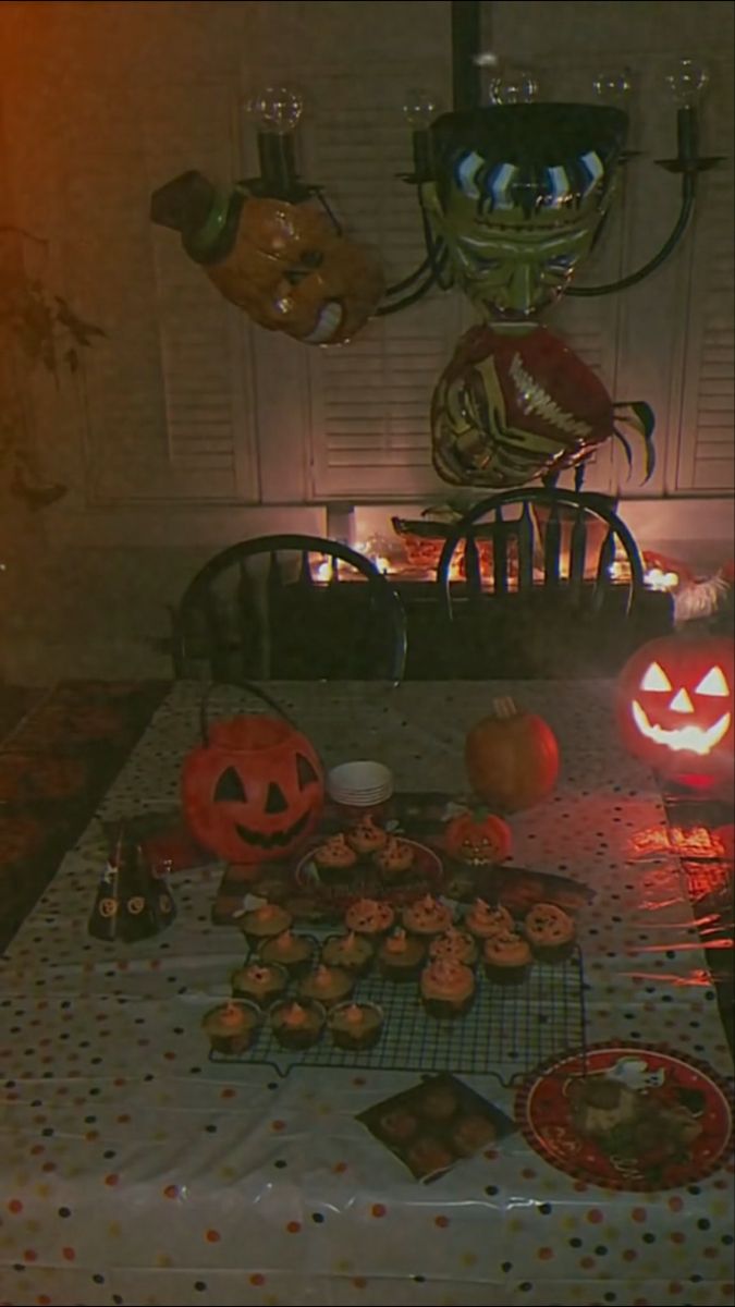 a table topped with lots of halloween treats