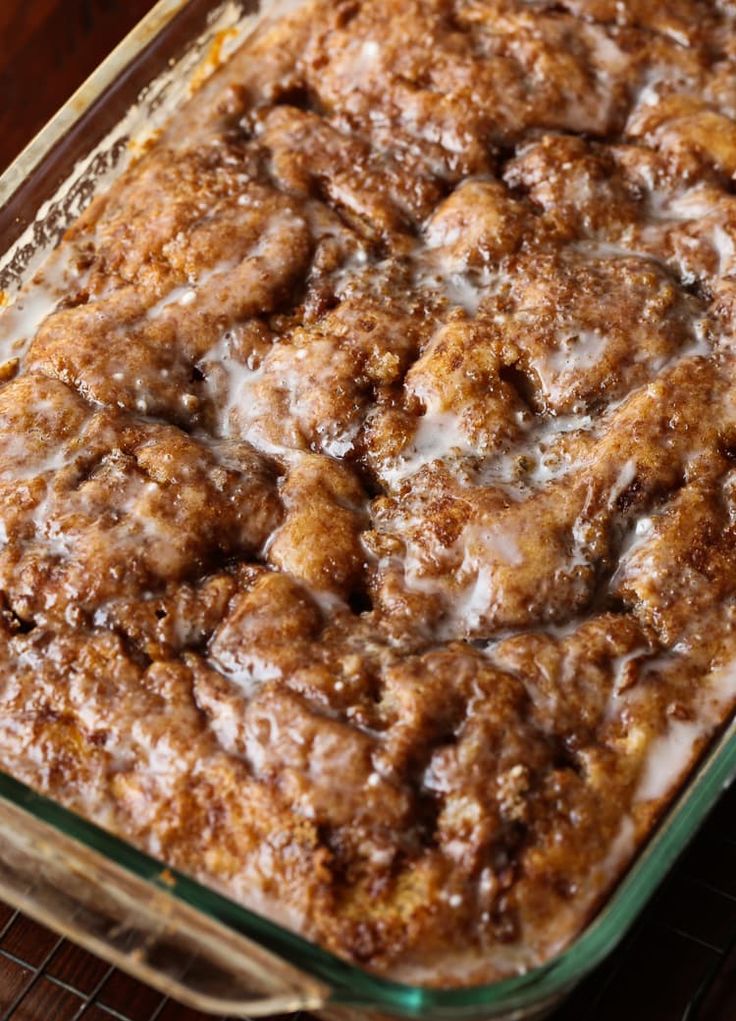 a casserole dish with cinnamon rolls in it on a cooling rack, ready to be eaten