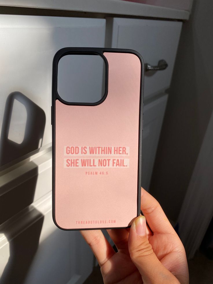 someone is holding up their phone case that says god is within her she will not fail