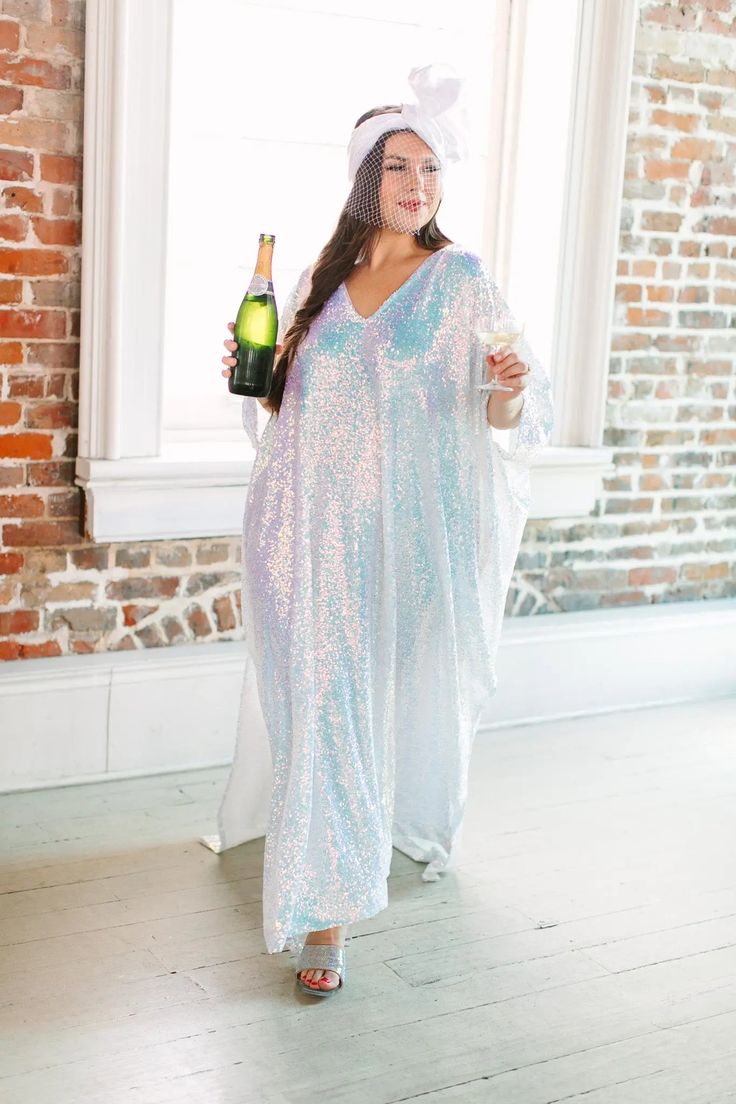 Be the life of the party in this long sequin caftan! This show-stopping caftan is adorned with shimmering sequins that will catch the light and turn heads. With a flowy, relaxed fit, it combines style and comfort. The long length ensures you'll bring the fashion drama, while the sequins add a touch of glamour to your look. These comfortable sequins on mesh are ulined for maximum breeze. Spring Party Kaftan With Sequins, Summer Party Sequined Kaftan, Summer Party Sequin Kaftan, Summer Party Kaftan With Sequins, Sequin V-neck Wedding Kaftan, Festive Sequin Maxi Length Kaftan, Wedding Sequined Maxi Kaftan, Summer Festive Sequined Kaftan, Festive Maxi-length Sequined Kaftan