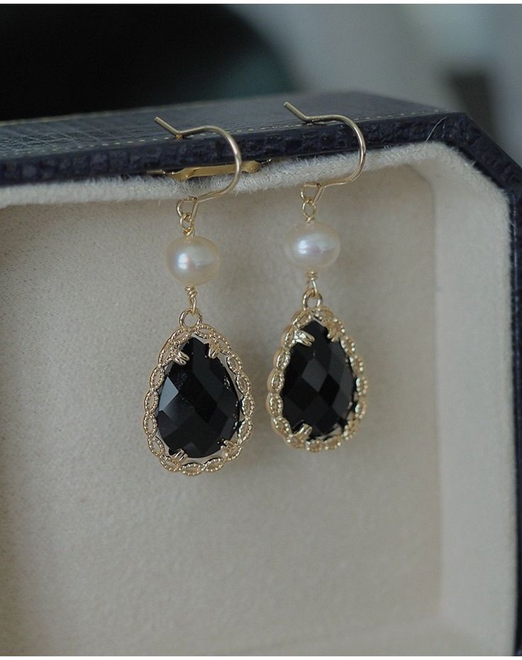 Luxury gothic style black onyx gemstone teardrop dangle sector earrings, with best quality natural pearl and stunning 14K Gold-filled lace in details, delicate and luxurious vintage vibes, absolutely gorgeous! We chose the finest 14k filled REAL gold to create this beautiful earrings, it shines beautifully from every angle, and the color last beautifully longer. Perfect gift idea for yourself and your loved one. ♥ All of our jewelry are carefully handmade with delicate and exquisite details, all designed and made in Manhattan, New York. 💎 Features: ♥ Handcrafted ♥ Material: Finest 14K Gold Filled ♥ Main stone: Black agate/onyx gemstone ♥ Side stone: Natural pearl ♥ Ear Wire Closure 💎 Details: ♥ Approximate Measurements: - Length: 1.75 inches - Width: 0.5 inches ♥ Nickel/Lead Free, Hypoal Feminine Earrings, Natural Pearl Earrings, Black Jewel, Lace Earrings, Onyx Gemstone, Gold Lace, Natural Pearl, Black Earrings, Gothic Style