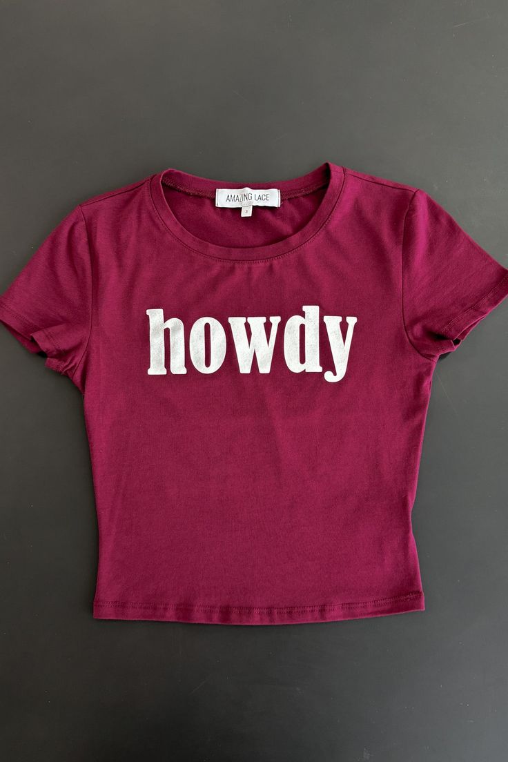 Our #1 selling Howdy tank just became a TEE!! Make sure you not only grab the cutest Howdy tank but now have to get the TEE! Fitted short sleeve cropped babydoll tee Material is Cotton Hang to dry Model is wearing a small SHOP THE LOOK Small Medium Large Length 17" 18" 19" Bust 13.5" 14.5" 15.5" Cute Crew Neck Tank Top With Letter Print, Fitted Crew Neck Tank Top With Text Print, Fitted Red Slogan Top, Trendy Red Top With Funny Print, Fitted Crew Neck Graphic Tank Top, Cute Slogan Crop Top T-shirt, Casual Funny Text Crop Top T-shirt, Cute Letter Print Crop Top T-shirt, Cute Spring Tops With Funny Text