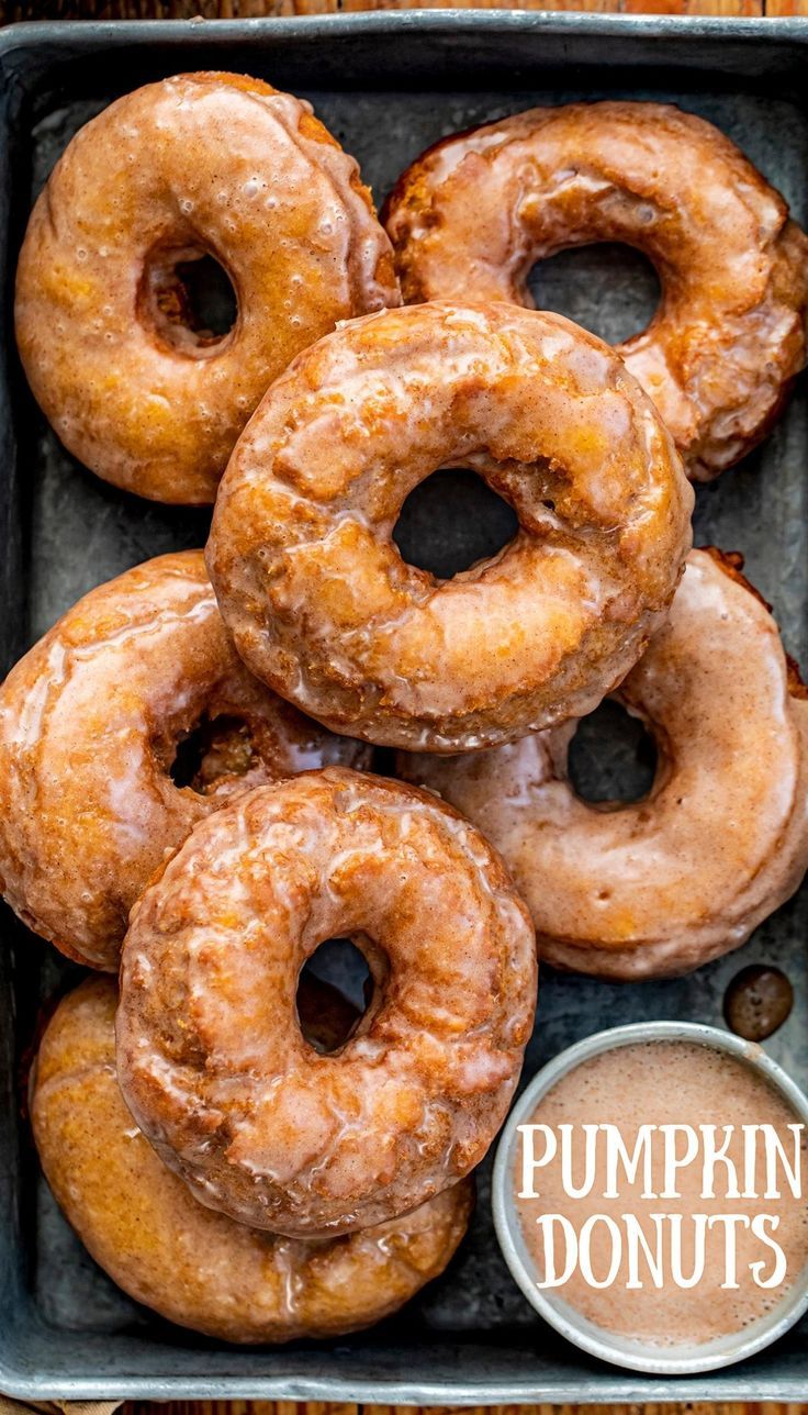 Overhead of a Pan of Glazed Pumpkin Donuts. Fall Donut Recipes, Pumpkin Doughnut Recipe, Pumpkin Donuts Baked, Micro Bakery, Pumpkin Spice Doughnuts, Pumpkin Donuts Recipe, Pumpkin Donut, Pumpkin Fritters, Pumpkin Doughnut