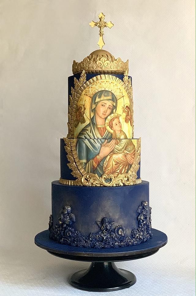 a three tiered cake decorated with an image of the virgin mary and child jesus