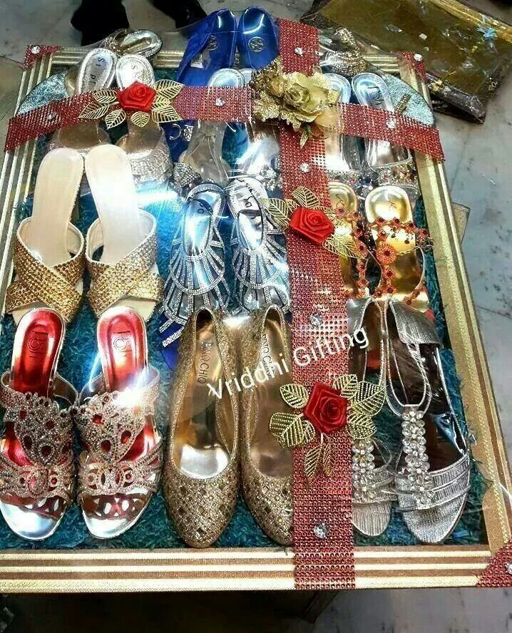 there are many pairs of shoes in the box on the table and one is red