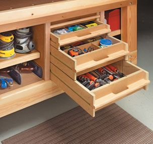 the workbench storage system is open to show tools and other items in it