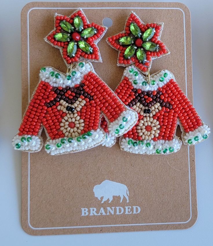 We only have limited quantities of these! Beaded-Lightweight!  Handcrafted Christmas Sweater Earrings!  Featuring Rudolf and his red nose, these Christmas sweater earrings are the icing on top of your holiday outfit!   Earrings are approximately 2.5 inches long and 2 inches wide at the widest point.  This is a handcrafted item and ships from a family owned small business in Texas. Red Novelty Christmas Jewelry, Novelty Red Christmas Jewelry, Red Novelty Jewelry For Christmas, Red Christmas Novelty Jewelry, Red Earrings For Winter Gift, Festive Christmas Beaded Earrings, Handmade Beaded Earrings For Christmas, Fun Red Beaded Earrings For Gift, Holiday Red Handmade Beaded Earrings