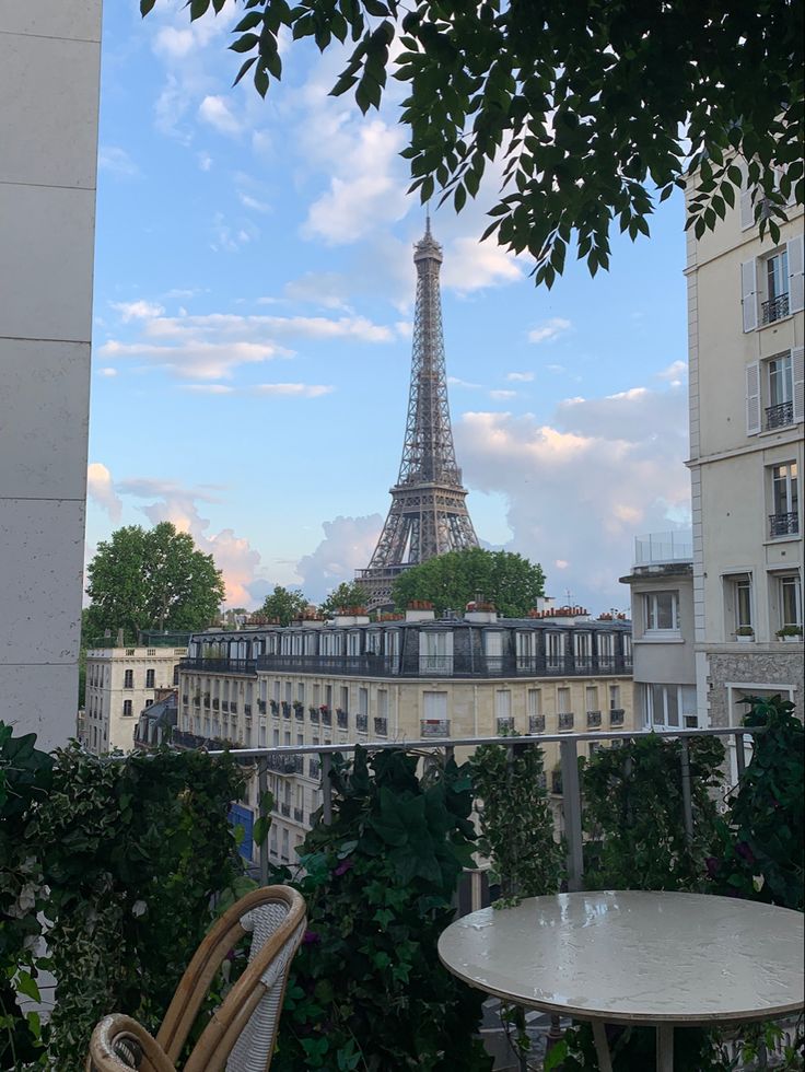 the eiffel tower is seen from an apartment balcony