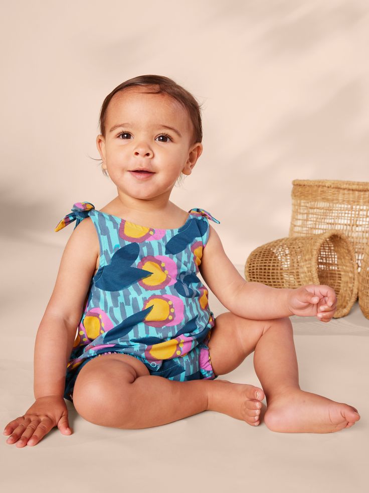 From our Kenya collection, this adorable printed romper is made of super lightweight and breathable 100% soft cotton jersey that will keep its color and shape, wash after wash. Features adjustable shoulder ties, inseam snaps, and elastic leg openings for easy dressing and diaper changes. Falls at mid-thigh. Playful Printed Cotton Bodysuit, Printed Bubble Romper For Summer Playwear, Playful Printed Bubble Romper For Playtime, Playful Printed Bubble Romper For The Beach, Playful Printed Bubble Romper For Beach, Playful Printed Cotton Bubble Romper, Multicolor Cotton Onesie For Summer, Sleeveless Printed Bubble Romper For Summer, Multicolor Cotton Bodysuit For Spring