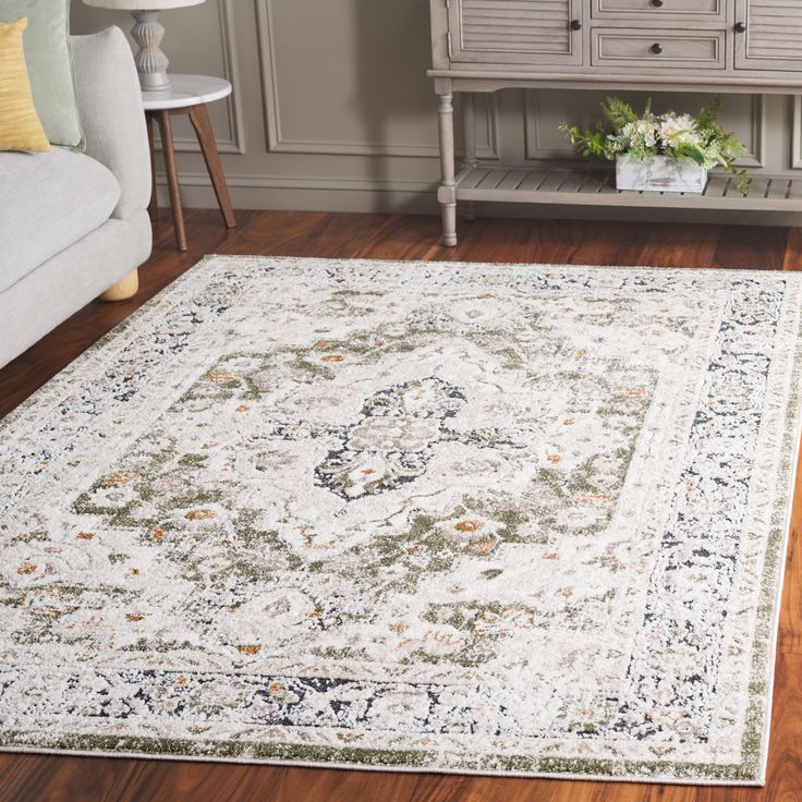 a living room area with a white rug on the floor