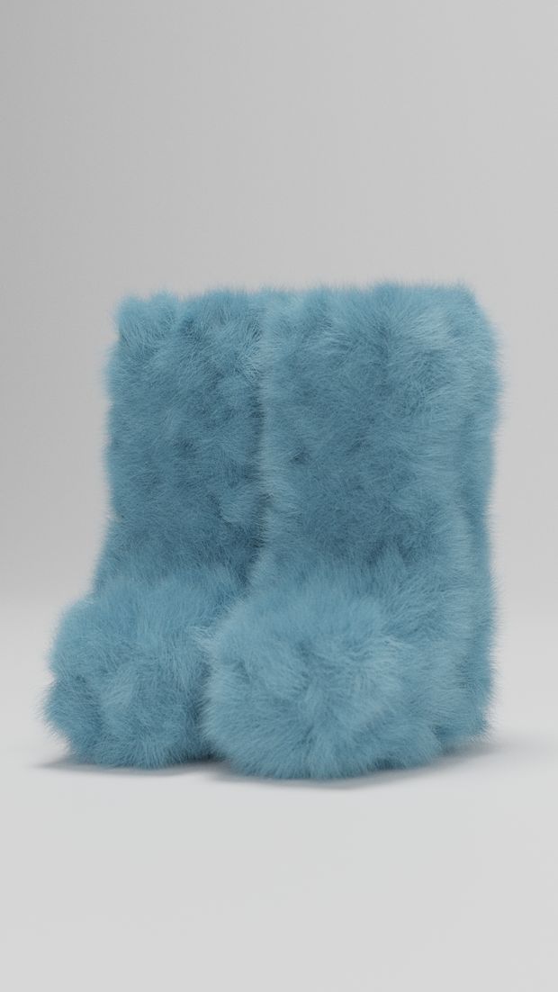 a pair of blue furry boots sitting on top of each other