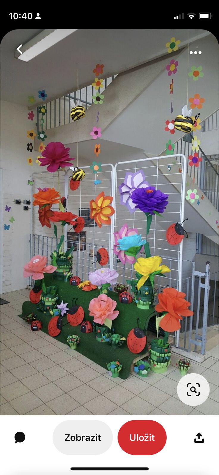 colorful paper flowers are hanging from the ceiling