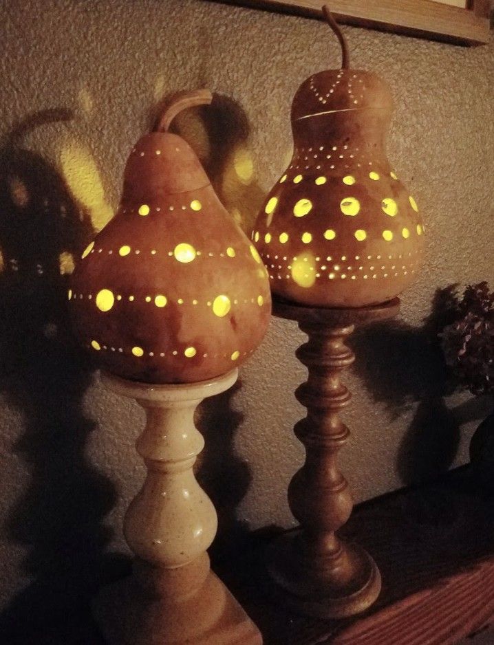 two wooden candlesticks with yellow lights on them