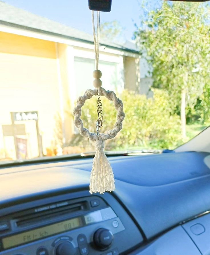 a car dashboard with a key chain hanging from it's center console and steering wheel