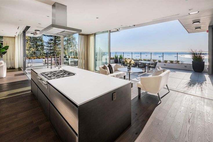 an open kitchen and living room with ocean view