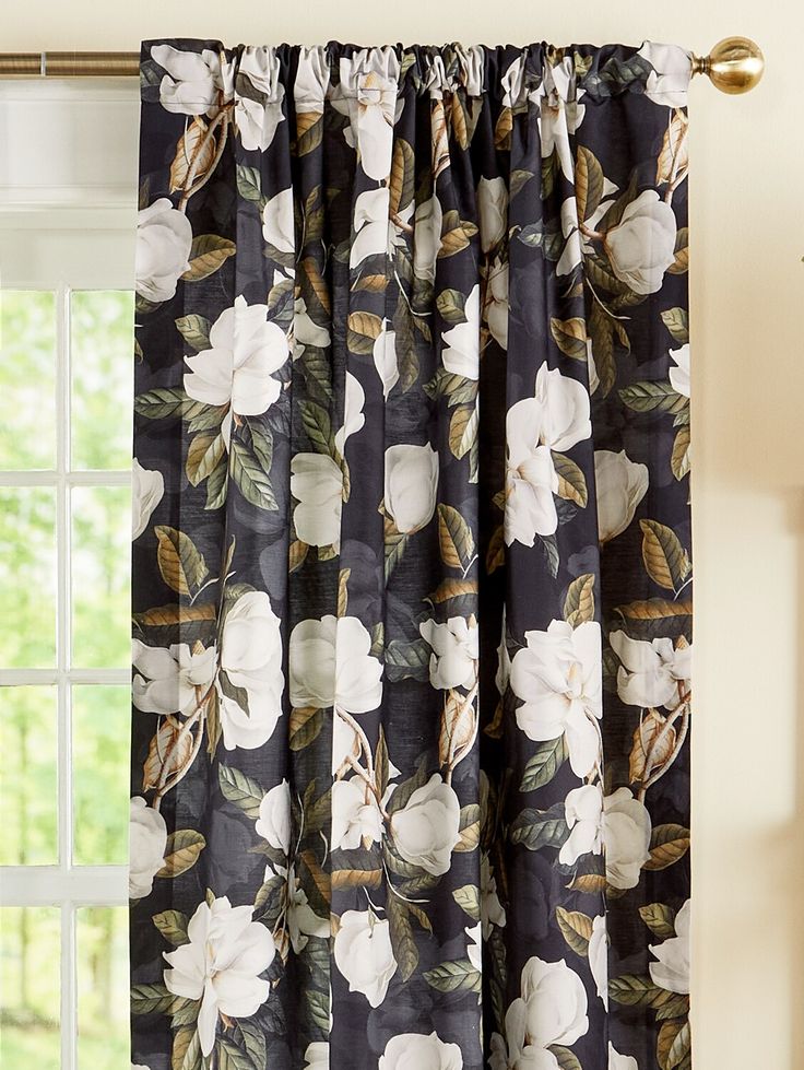 the curtains are hanging on the window sill in front of an open window with white flowers