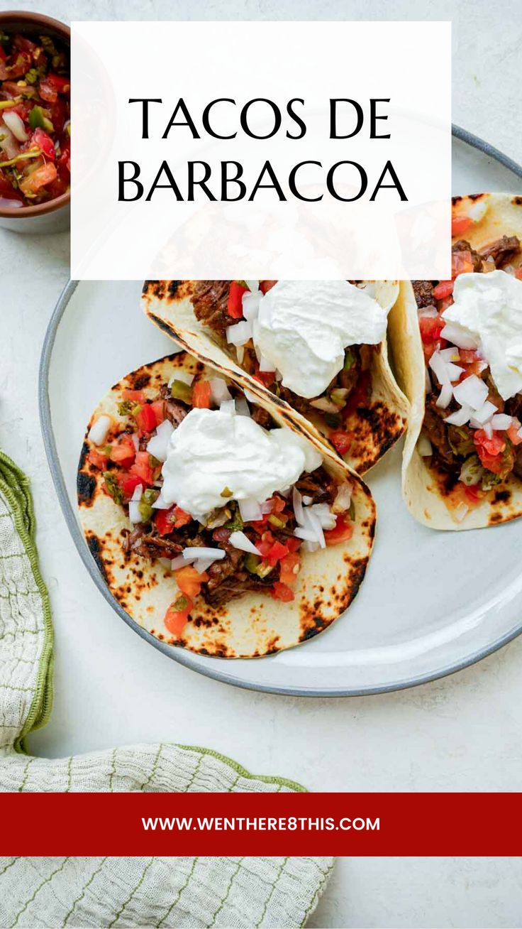 tacos de barbacoa on a plate with sour cream in the middle