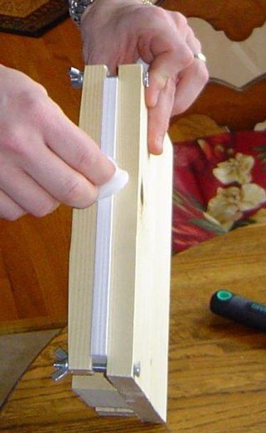 a person is using a piece of wood to make a book