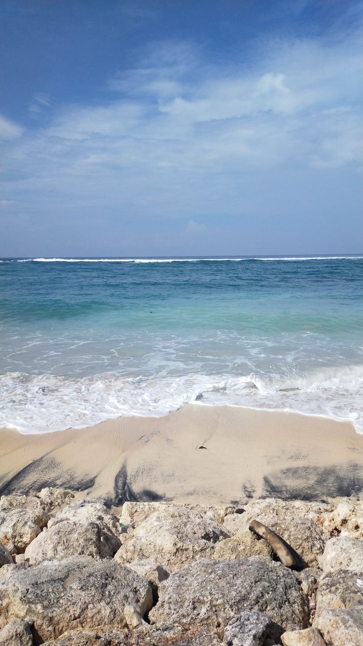 the beach is covered with rocks and water