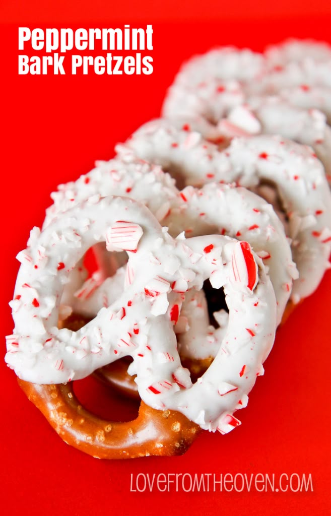 two pretzels covered in white frosting and peppermint sprinkles