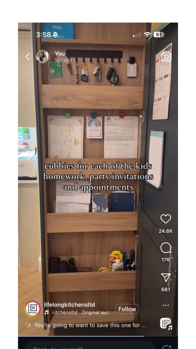 an open book shelf with papers and other items on it, next to a phone