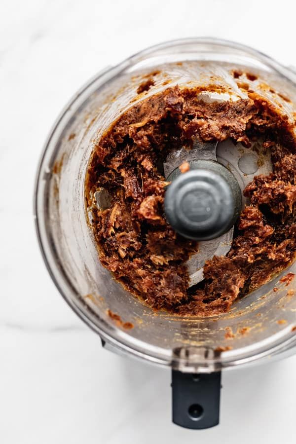 a food processor filled with meat and spices