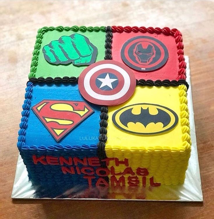 a square cake decorated with superheros and stars