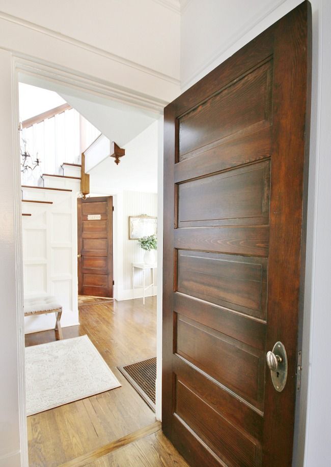 an open door leading to a living room with hardwood floors and hard wood flooring