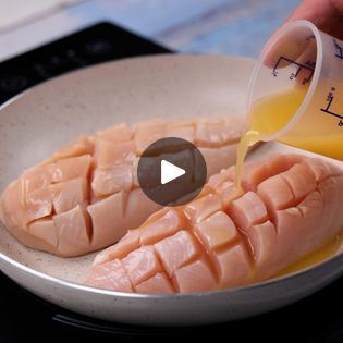 someone is pouring orange juice into some kind of meat in a pan on the stove