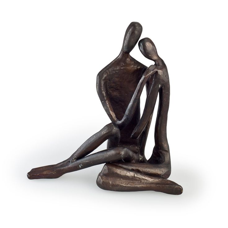 a bronze statue of two people sitting on the ground with their arms around each other