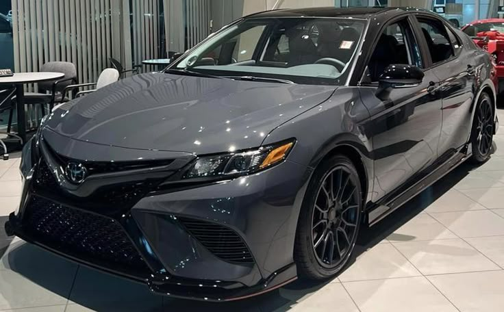 a gray car is on display in a showroom