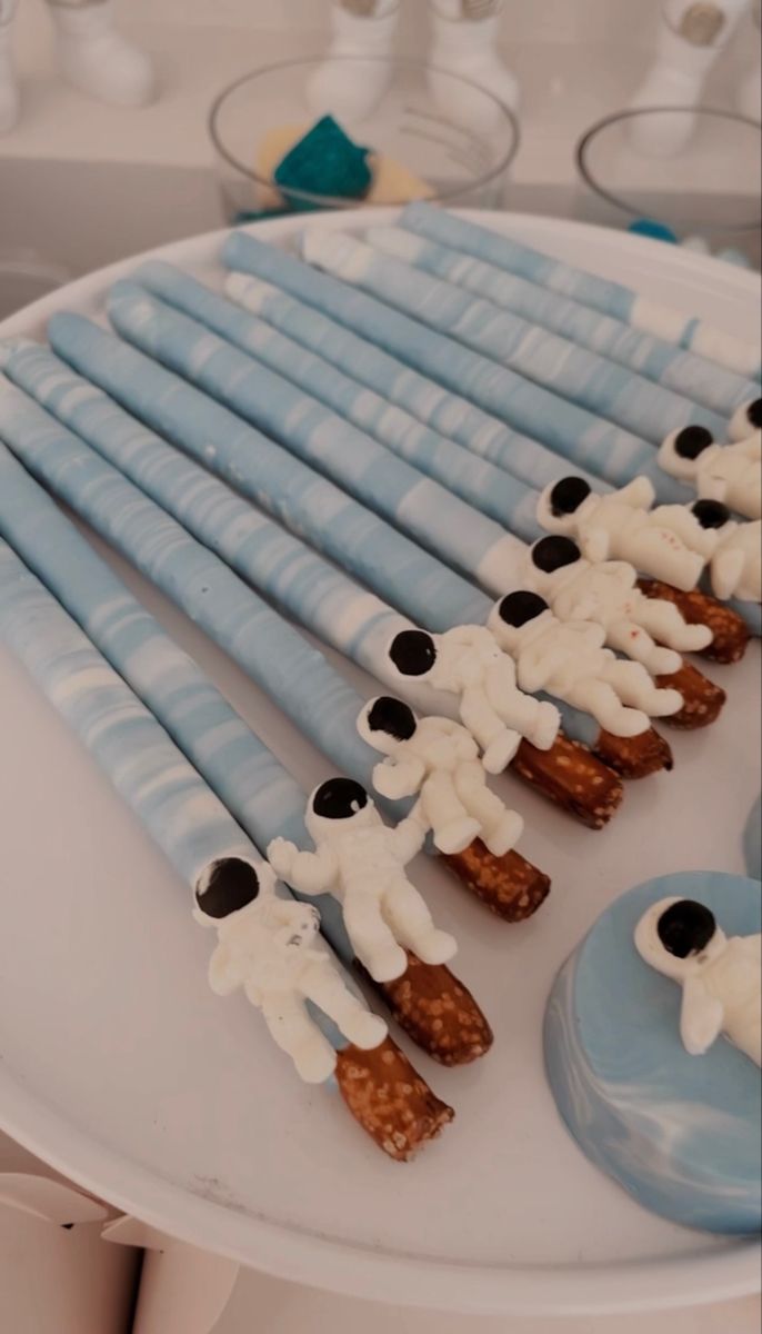 there are many blue and white desserts on the plate with toothbrushes in them