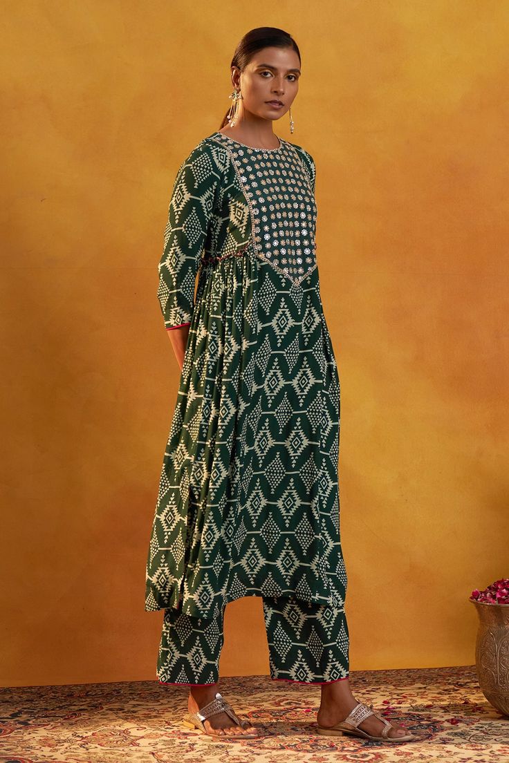 Bottle green kurta with hand embroidered yoke and all-over Moroccan prints. Comes with printed pants.
Component: 2
Pattern: Printed, Embroidered
Type Of Work: Moroccan Prints, Floral Work
Neckline: Round
Sleeve Type: Three Quarter
Fabric: Crepe
Color: Green
Other Details: 
Side gathered details
Floral embroidered highlights
Occasion: Mehendi and Haldi - Aza Fashions Green Mulmul Palazzo Set With Zari Work, Green Anarkali Palazzo Set In Mulmul, Green Cotton Anarkali Set For Navratri, Green Anarkali Set In Mulmul, Green Palazzo Set With Zari Work, Green Anarkali Cotton Salwar Kameez, Green Mulmul Anarkali Set With Straight Kurta, Festive Green Mulmul Palazzo Set, Transitional Green Cotton Traditional Wear