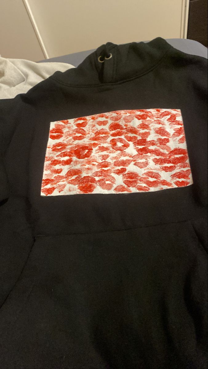 a black shirt with red and white designs on it